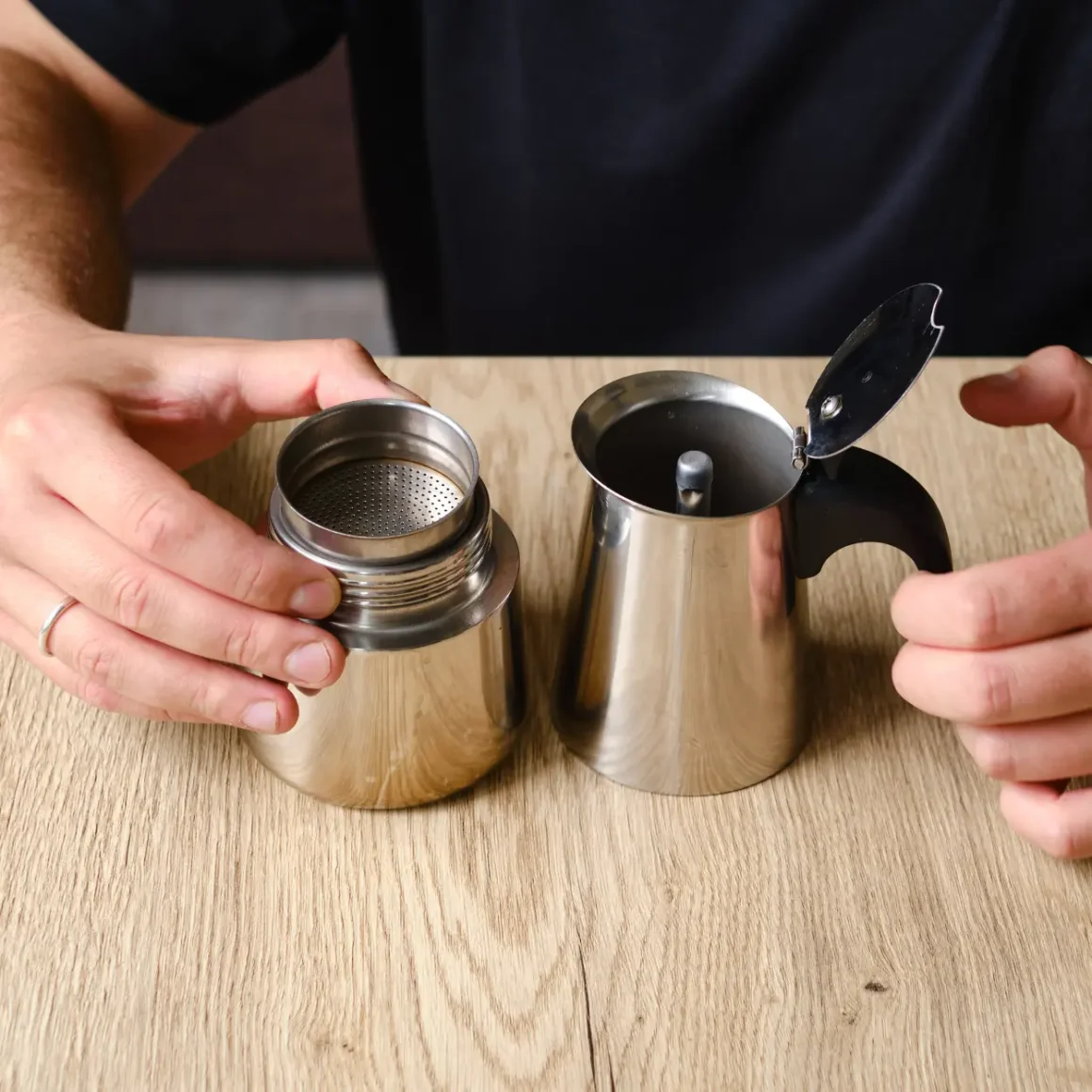 a person holding a component of moka pot