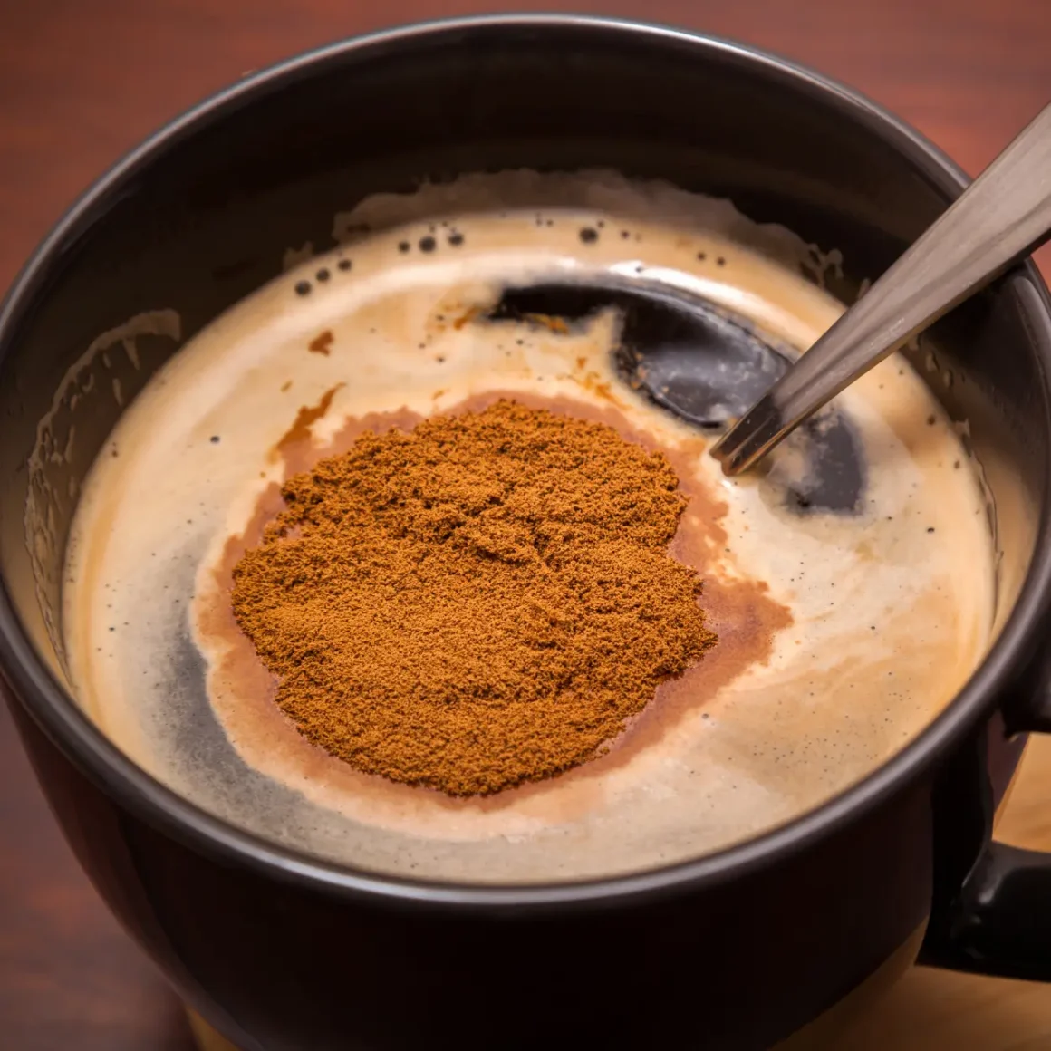 a cup of coffee with an espresso powder and spoon in it