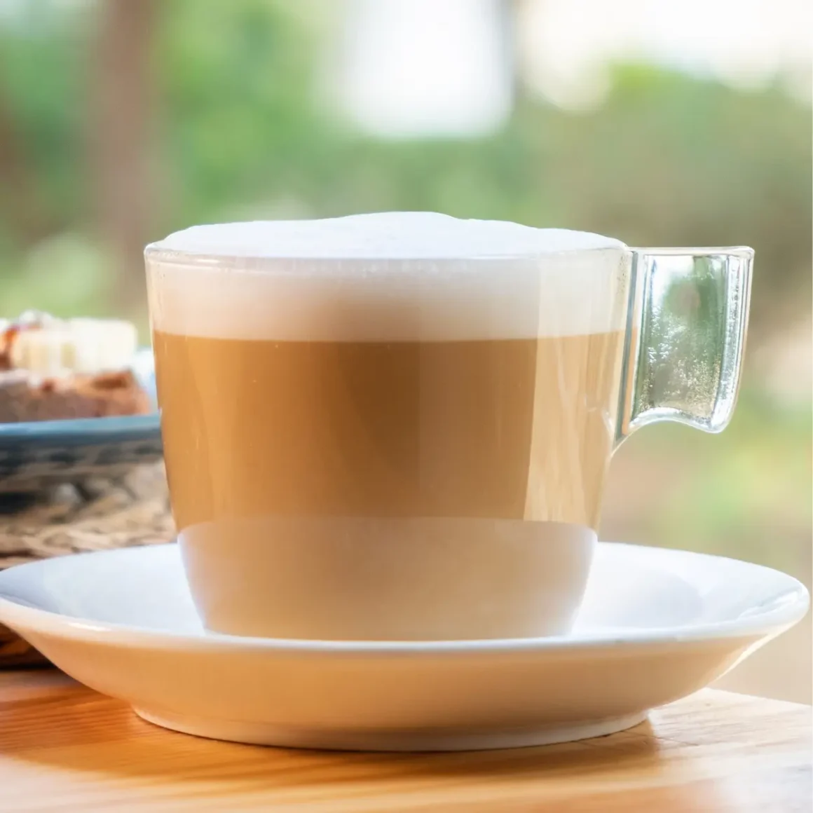 a cup of cafe con leche on a plate