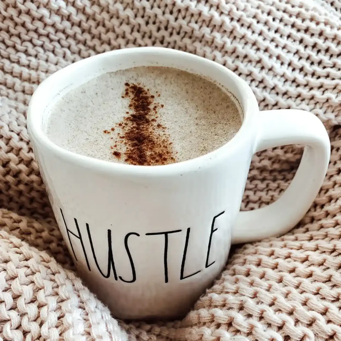 a ceramic mug with a coffee in it