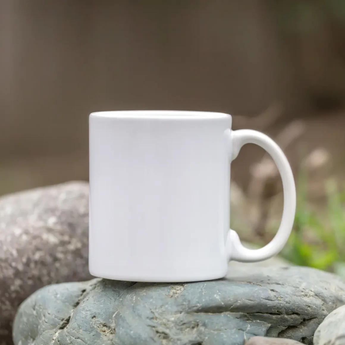 a white porcelain mug on a rock