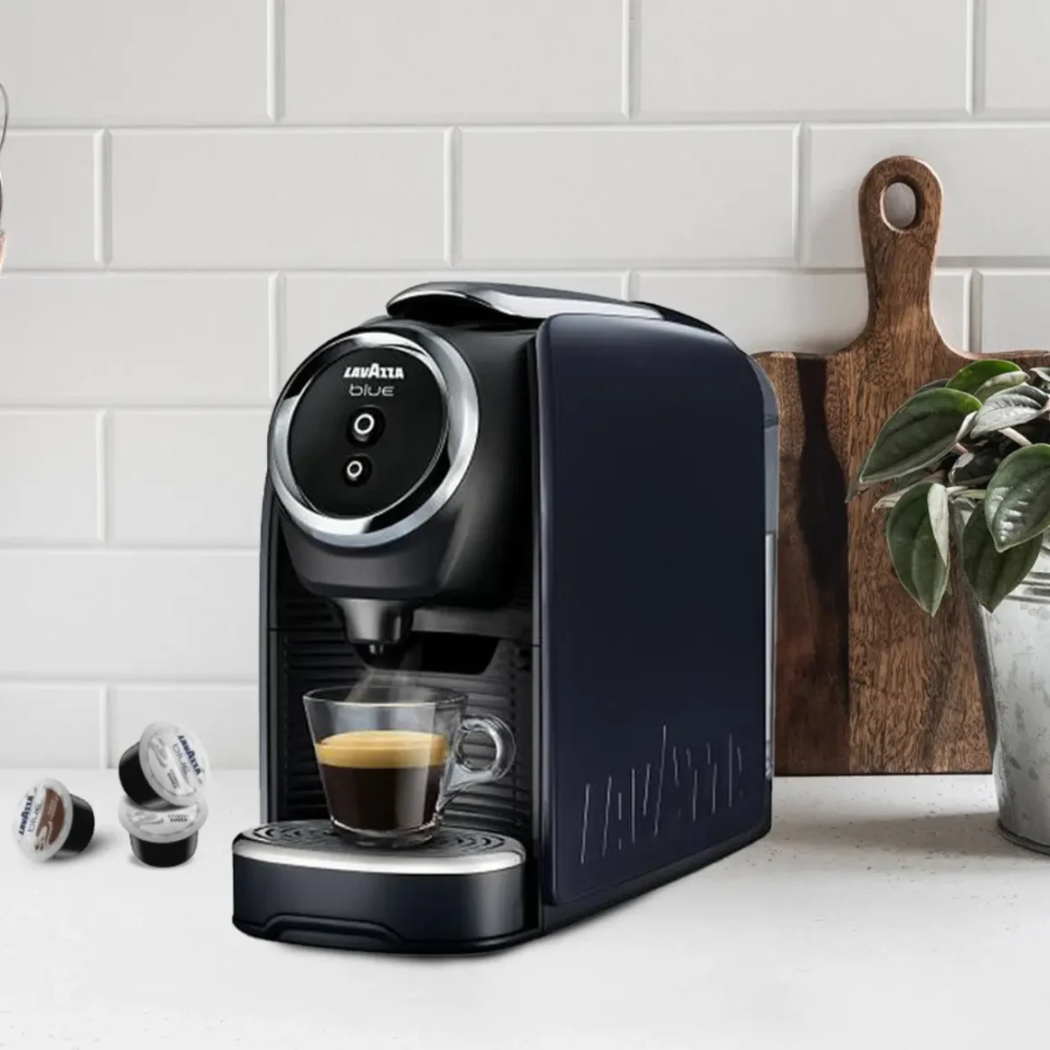 a black lavazza blue classy mini coffee maker with a cup of coffee