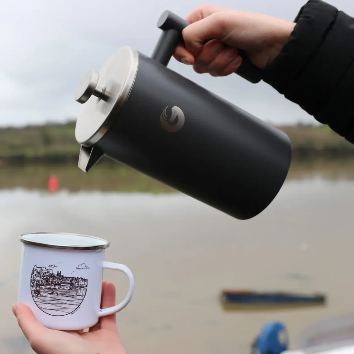 a person pouring a coffee into a mug from a coffee gator french press coffee maker