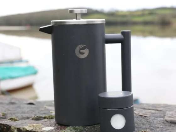 a coffee gator french press coffee maker on a rock