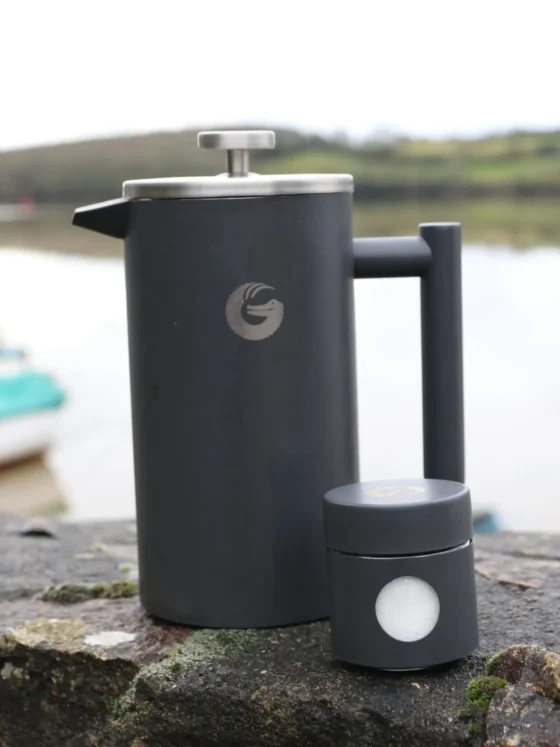 a coffee gator french press coffee maker on a rock