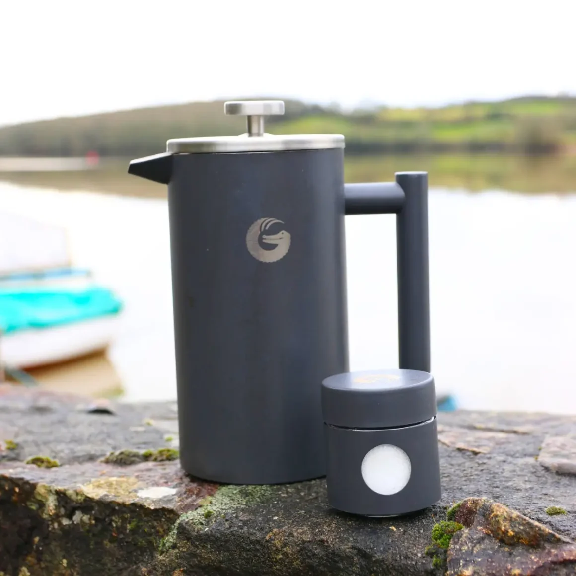 a coffee gator french press coffee maker on a rock