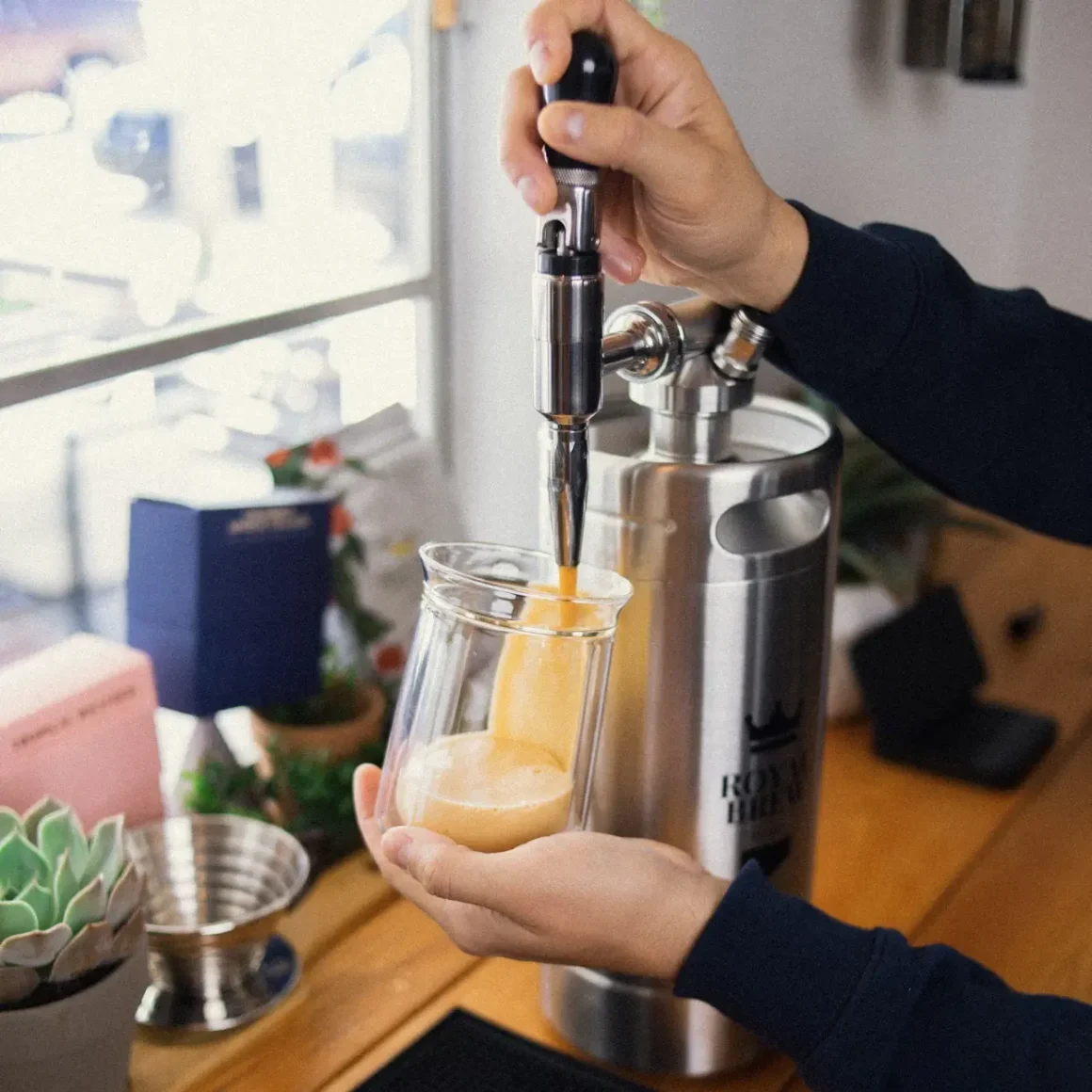 barista pouring a coffee into a glass