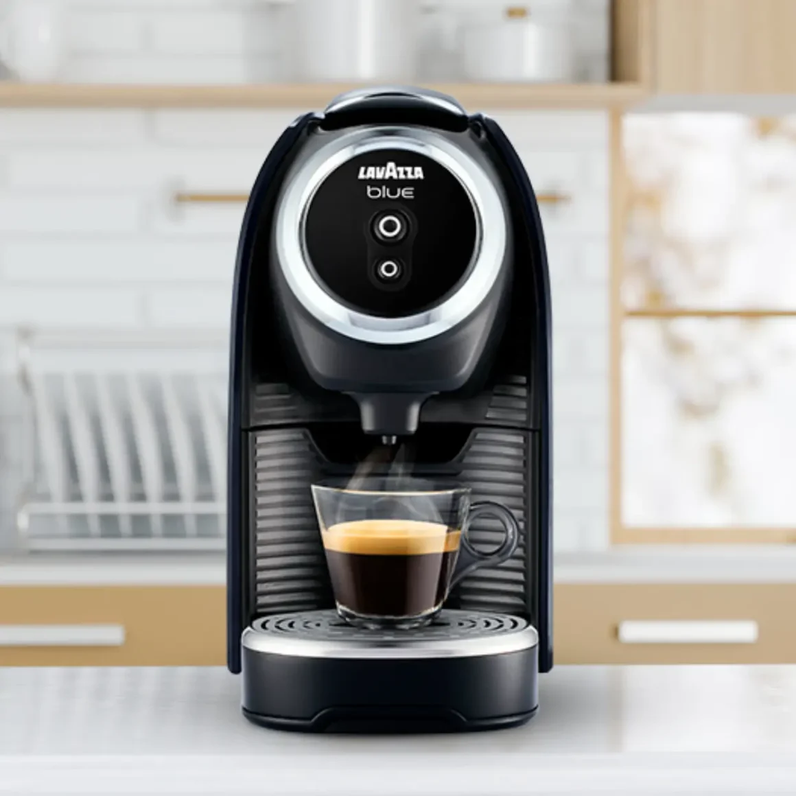 a lavazza blue classy mini coffee maker with a cup of coffee